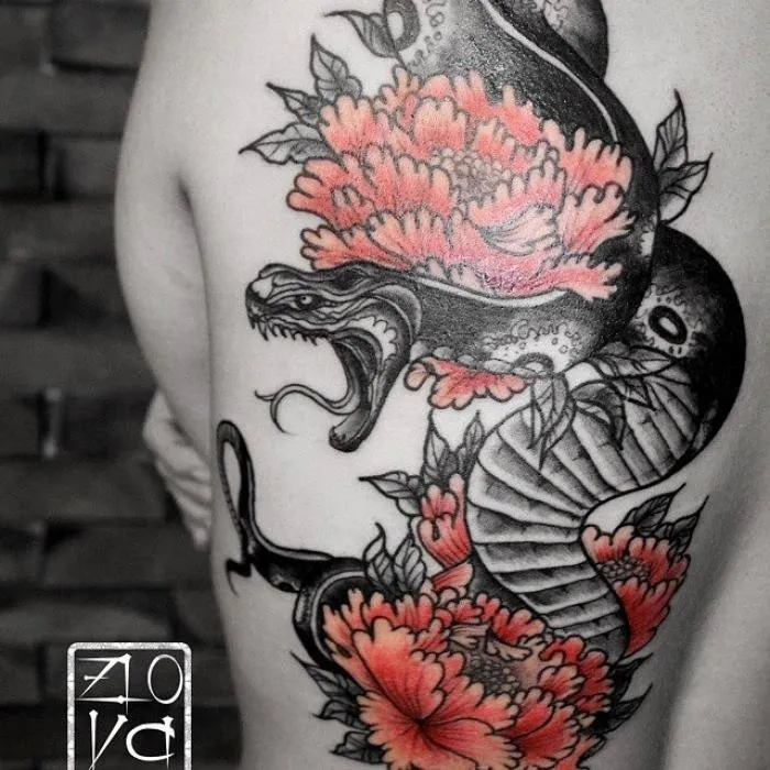Татуировка черно-белого дракона с цветами на плече